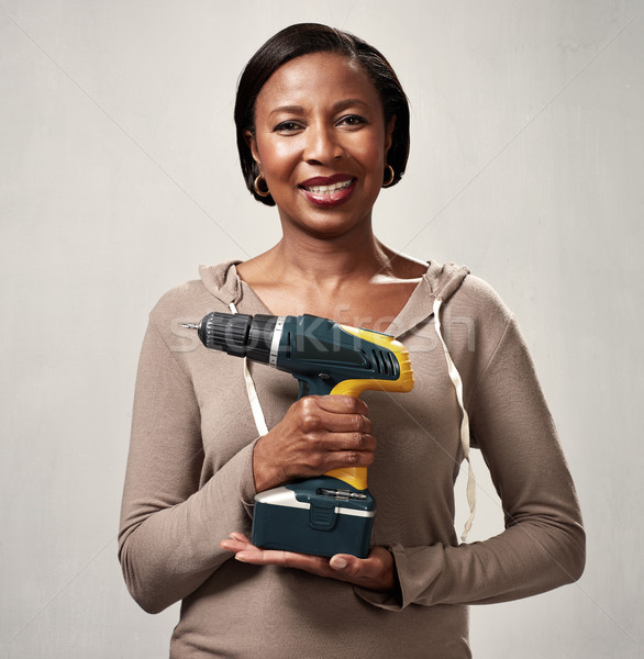 African woman with drill Stock photo © Kurhan