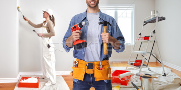 Construction worker with drill and hammer Stock photo © Kurhan
