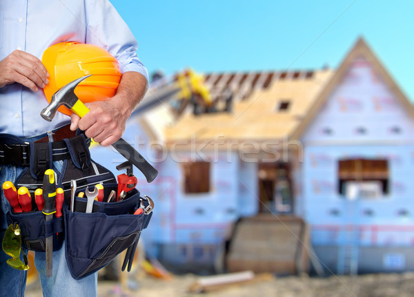 Construction worker with hammer and tools. Stock photo © Kurhan