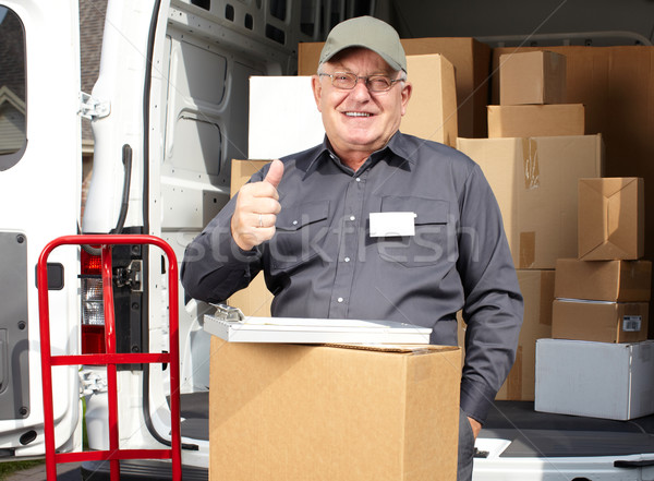 Senior delivery man with parcel near truck. Stock photo © Kurhan
