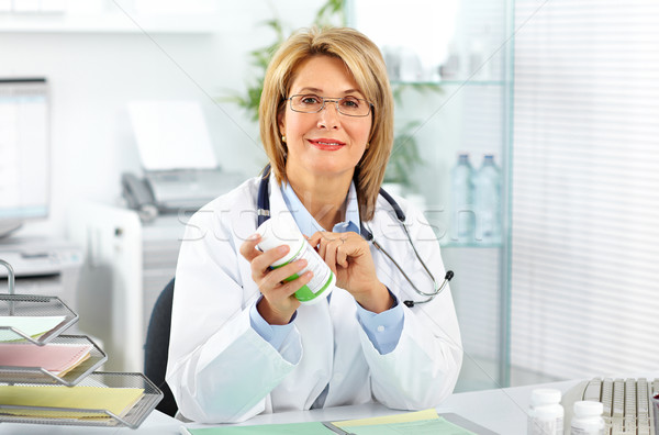 Mature doctor woman with pills. Stock photo © Kurhan