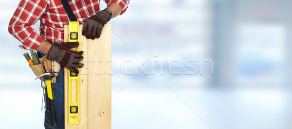 Builder with level and wooden planks. Stock photo © Kurhan