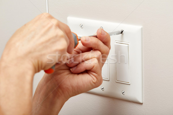 Przełącznik ręce elektryk śrubokręt naprawy Zdjęcia stock © Kurhan