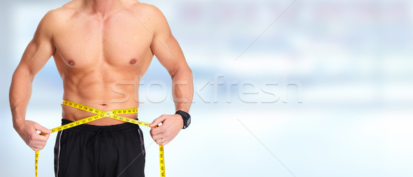 Homme abdomen mètre à ruban bleu fort [[stock_photo]] © Kurhan