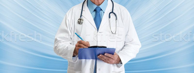 Doctor hands writing on clipboard Stock photo © Kurhan