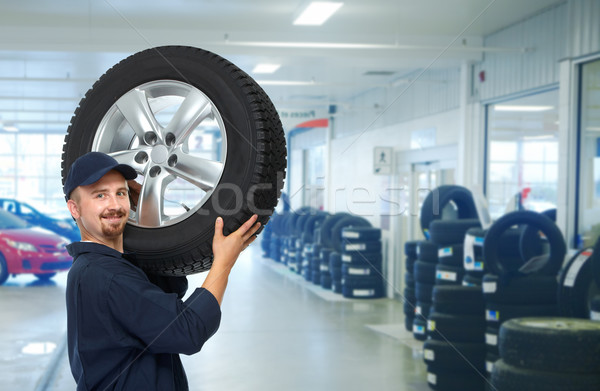 Car mechanic with a tire . Stock photo © Kurhan
