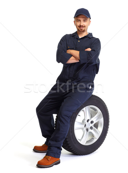 Car mechanic with a tire. Stock photo © Kurhan