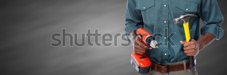 Worker man with hammer and drill. Stock photo © Kurhan