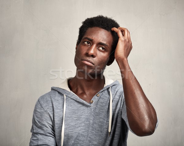 Pensando homem negro africano americano moço cinza parede Foto stock © Kurhan