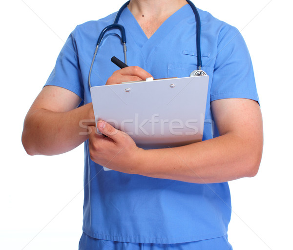 Hands of doctor with clipboard. Stock photo © Kurhan