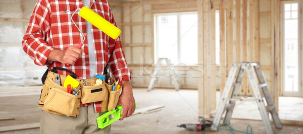 Builder handyman with paint roller. Stock photo © Kurhan