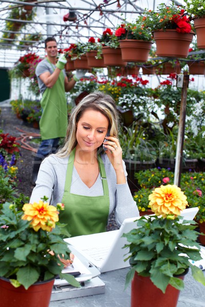 Florist working with flowers in greenhouse. Stock photo © Kurhan