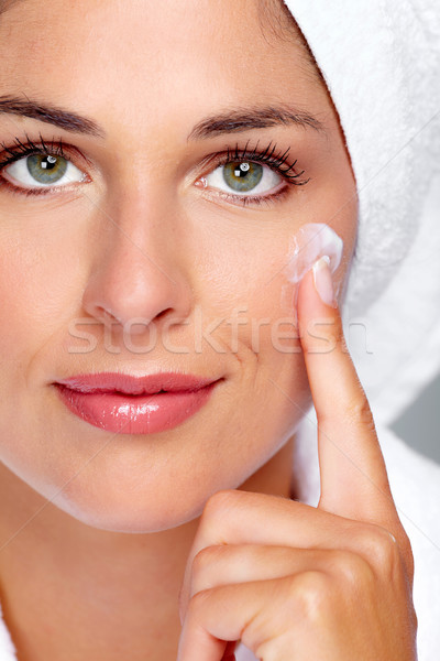 Beautiful woman face with moisturising  cream. Stock photo © Kurhan