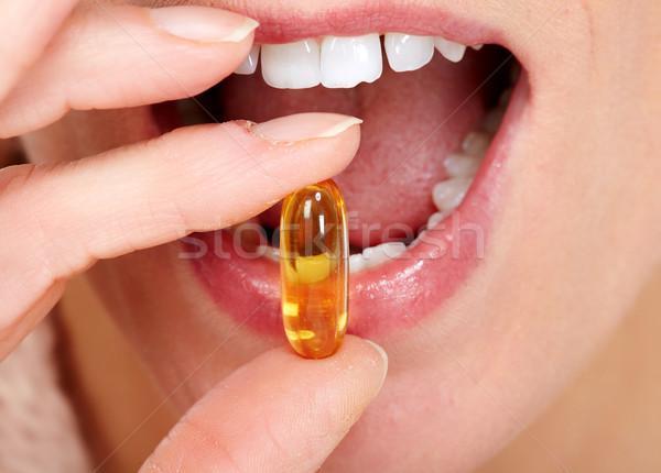 Donna bocca mangiare pillole mano Foto d'archivio © Kurhan