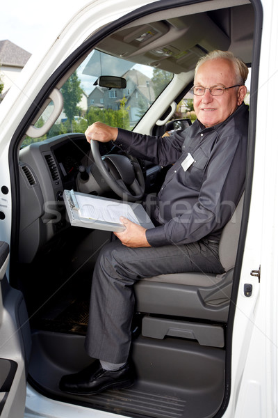 Elderly delivery man in a car. Stock photo © Kurhan