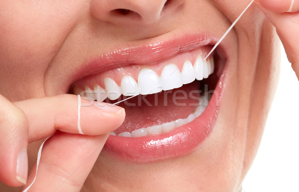woman smile with tooth floss Stock photo © Kurhan