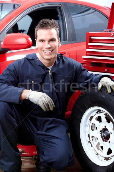 Auto mechanic changing tire. Stock photo © Kurhan