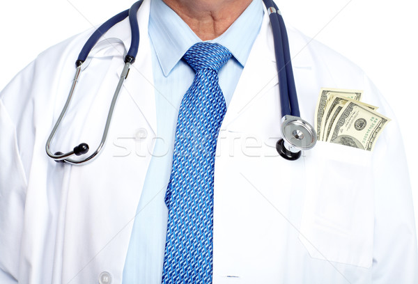 Hands of medical doctor with money. Stock photo © Kurhan