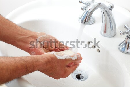 Man washing hands with soap and water. Stock photo © Kurhan