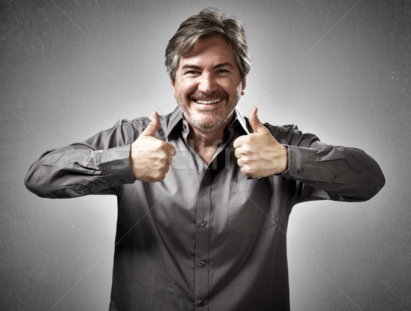 Happy man with thumbs. Stock photo © Kurhan