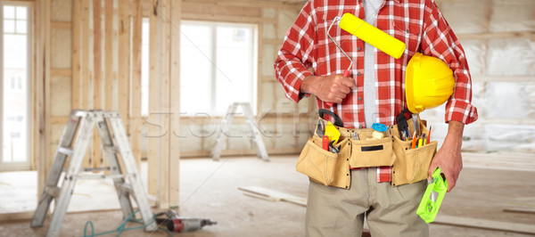 Builder handyman with paint roller. Stock photo © Kurhan