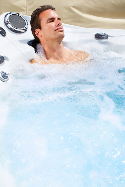 Happy man in jacuzzi. Stock photo © Kurhan