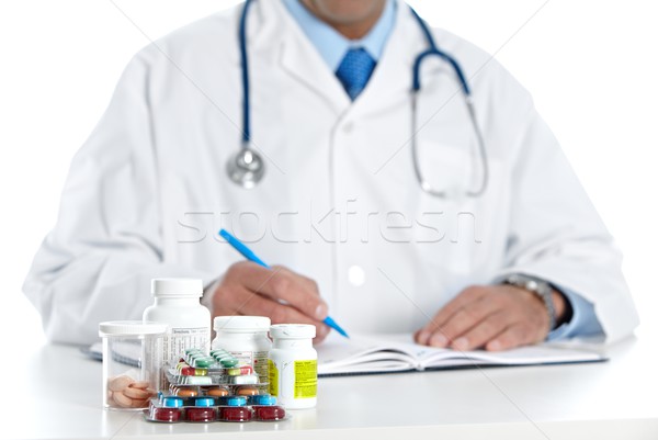 Doctor writing medical prescription. Stock photo © Kurhan