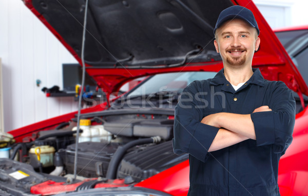 Smiling car mechanic in auto repair service. Stock photo © Kurhan