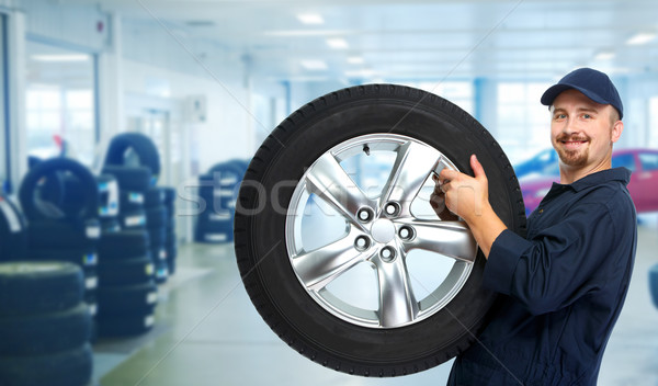 Car mechanic with a tire . Stock photo © Kurhan