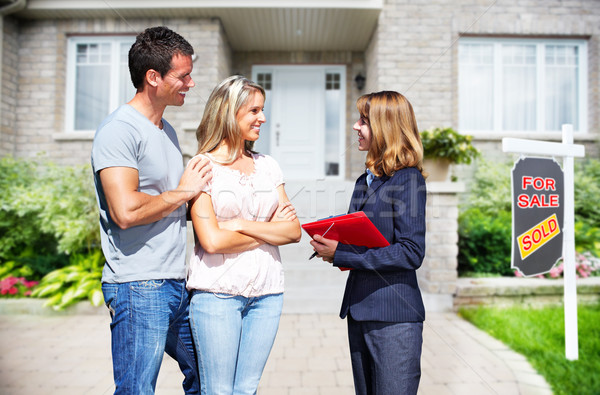 Stock photo: Real Estate agent woman with clients near new house.