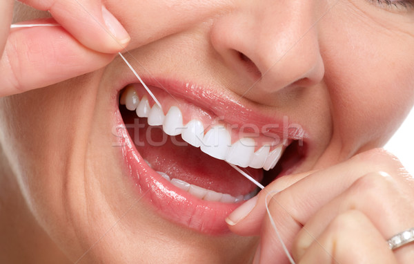 woman smile with tooth floss Stock photo © Kurhan