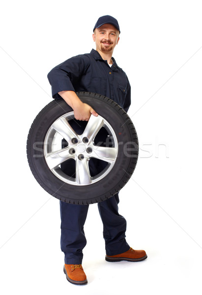 Car mechanic with a tire. Stock photo © Kurhan