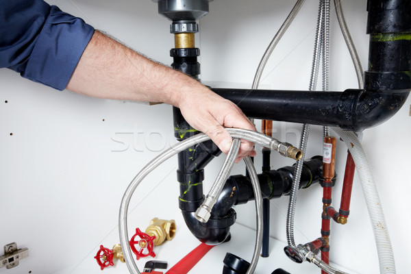 Hands of Plumber with a wrench. Stock photo © Kurhan