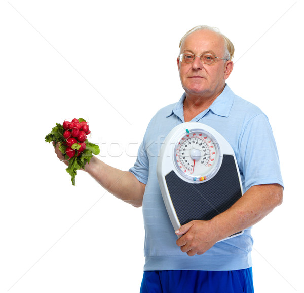 Senior man with scales and radish. Stock photo © Kurhan