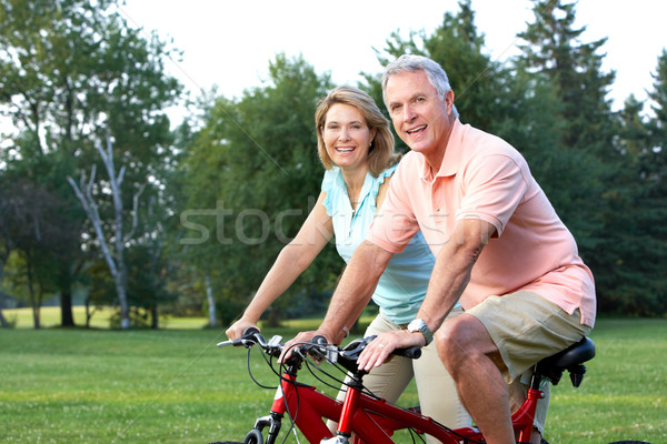 Stock photo: seniors couple biking