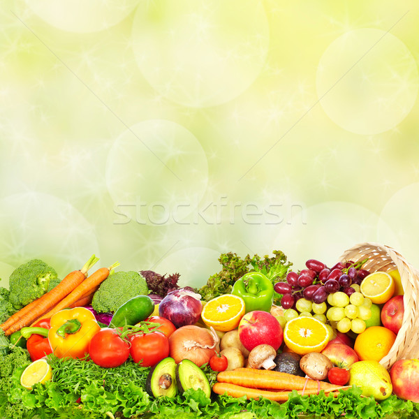 Vegetables and fruits over green background. Stock photo © Kurhan