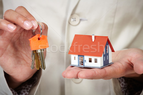Woman Hands with little house and key. Stock photo © Kurhan