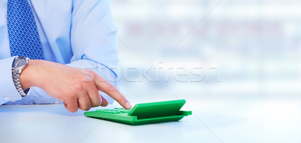 Hand with a calculator. Stock photo © Kurhan