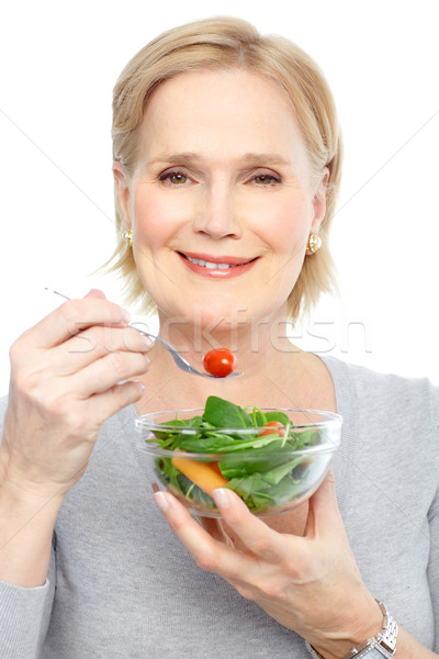 Kobieta jedzenie Sałatka dojrzały uśmiechnięta kobieta owoce Zdjęcia stock © Kurhan