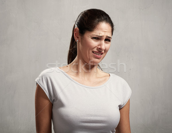 Girl disgusted face expression Stock photo © Kurhan