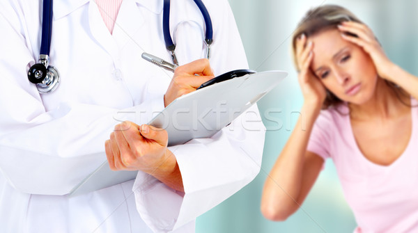 Hands of a medical doctor. Migraine. Stock photo © Kurhan