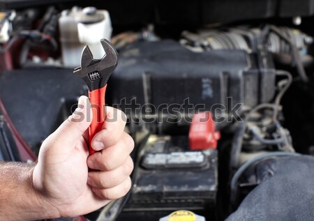 Stock photo: Hand of car mechanic with wrench.