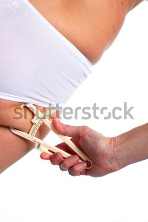 Woman measuring body fat. Stock photo © Kurhan