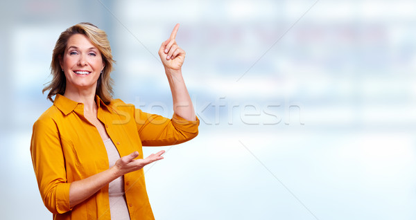 Beautiful senior woman presenting copy space. Stock photo © Kurhan