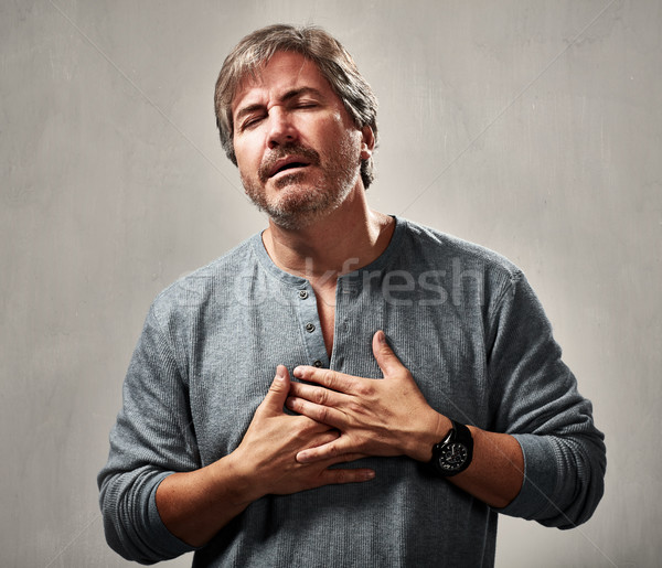 Férfi lehangolt portré szürke fal kéz Stock fotó © Kurhan