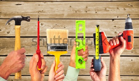 Hands of handyman with tools. Stock photo © Kurhan