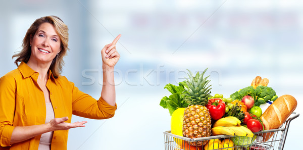 Beautiful senior woman presenting copy space. Stock photo © Kurhan