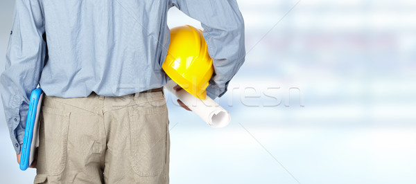 Engineer with helmet and blueprint. Stock photo © Kurhan