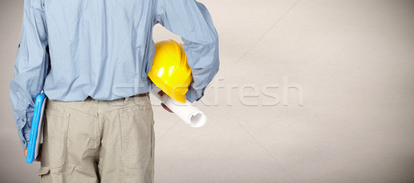 Engineer with helmet and blueprint. Stock photo © Kurhan