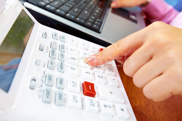 Hand with a calculator. Stock photo © Kurhan